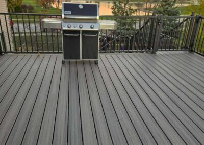 Deck with a grill, pond, and sunset